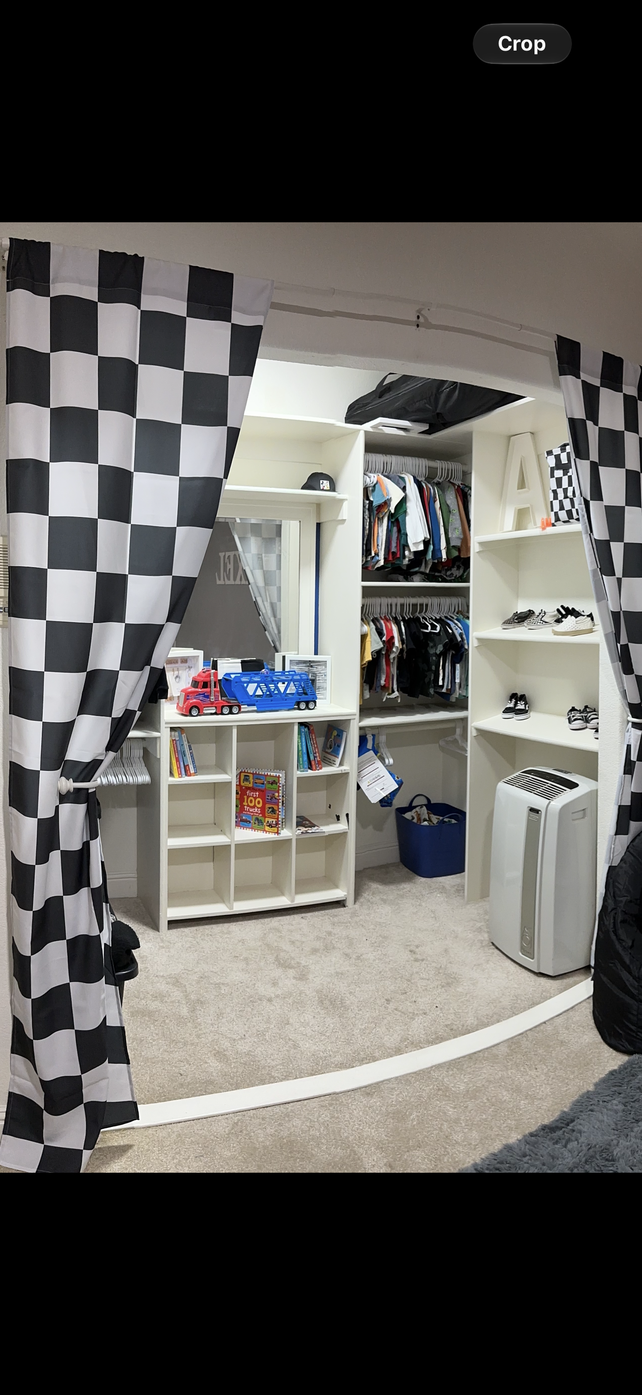 White closet storage with shelves, cubbies and two levels of hanging space